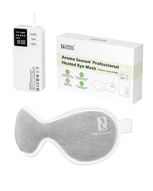 Aroma Season professional heated eye mask with packaging and power adapter on a white background